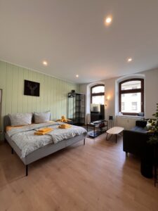 Möbliertes Schlafzimmer mit Doppelbett und Sitzbereich